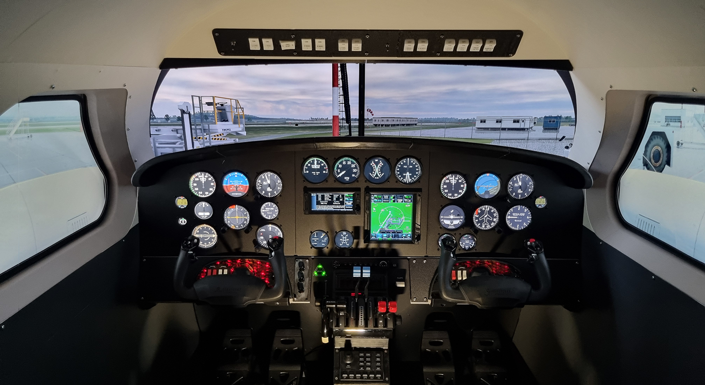 Interior of a Sim-Mech FlightPod simulator with dual controls and analog instruments