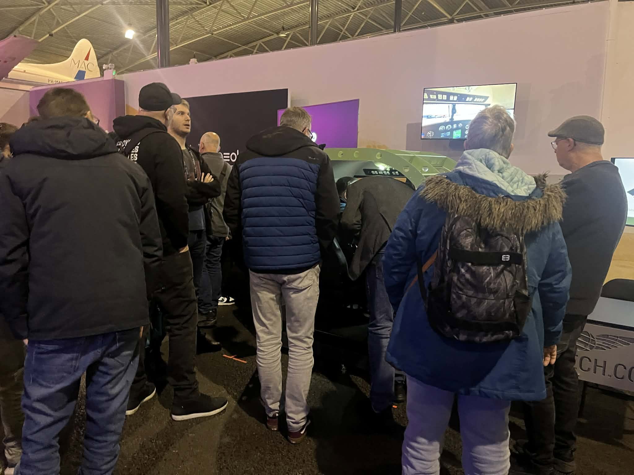 Visitors gathered around the FlightPod GA simulator at FSWeekend 2026